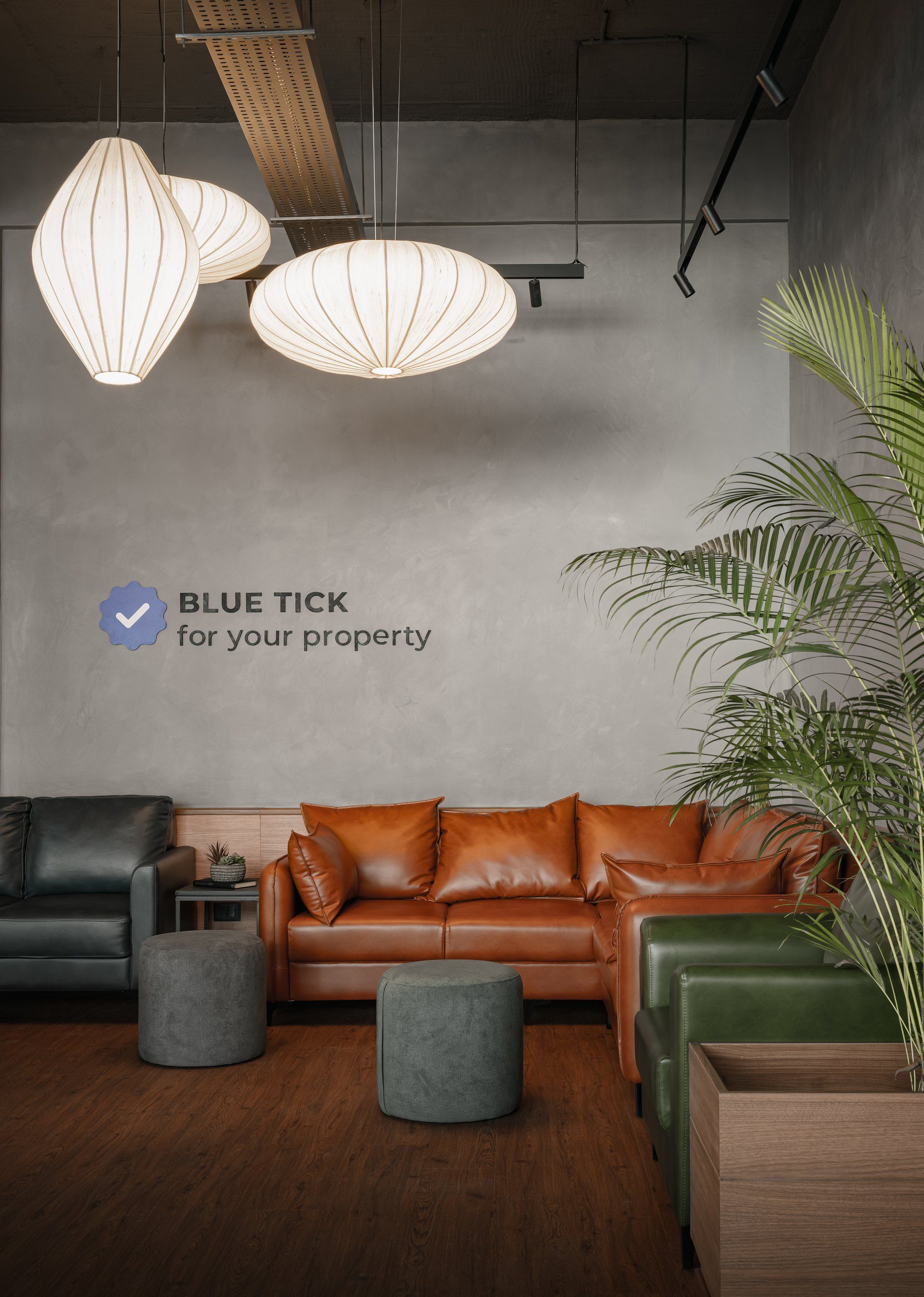 LeX lounge with lantern lights, leather sofas and a 'Blue Tick for your property' wall sign